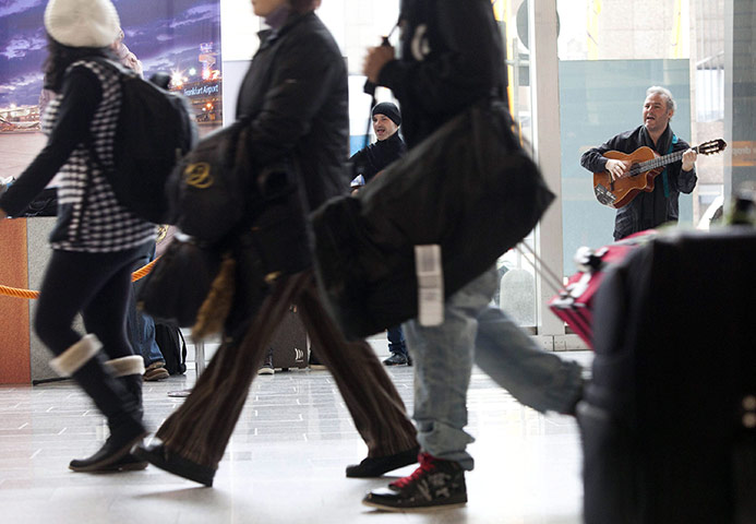 Travel Chaos: A band performs for waiting passengers at the airport in Frankfurt