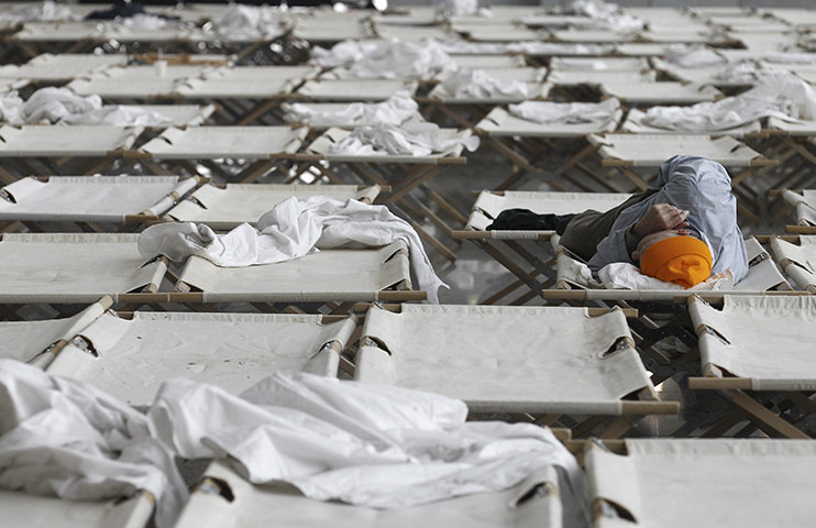 Travel Chaos: A traveller sleeps on a camp bed