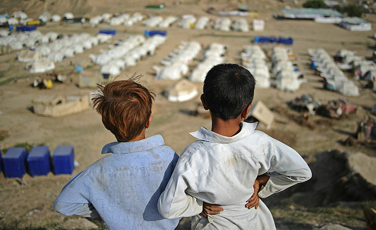 2010 year in MDG: Two boys look out over a large relief ca
