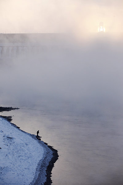 24 hours in pictures: A fisherman stands on the bank of the Yenisei River
