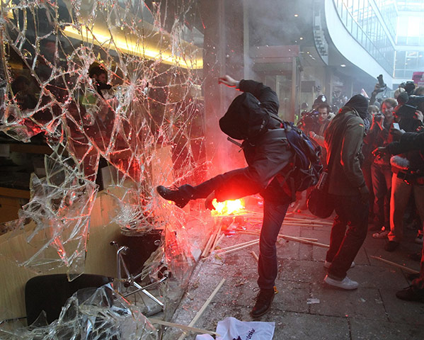 2010: year in pictures: A student fees demonstrator kicks the windows of Millbank Tower