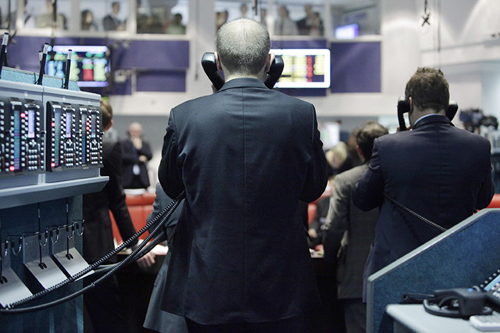 Week in Business: Traders speak on the telephone on the floor of the London Metal Exchange