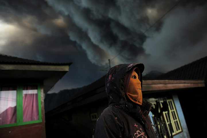 24 hours in pictures: An Indonesian man wears a mask to avoid inhaling ash