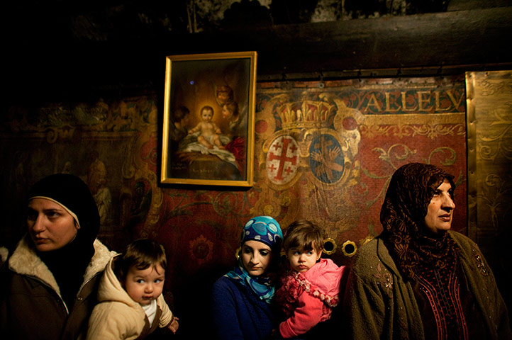 24 hours in pictures: Visitors stand under an icon in the Grotto of the Church of the Nativity