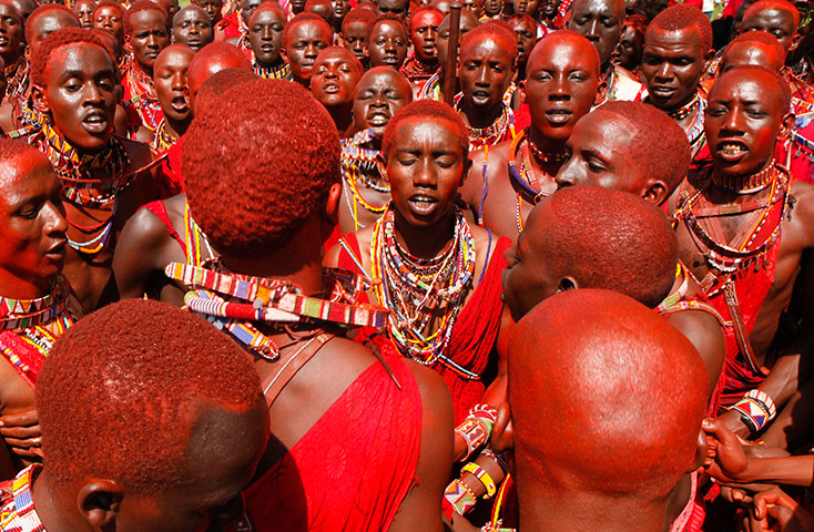 24 hours in pictures: Young Maasai warriors, dance together during an inauguration ceremony