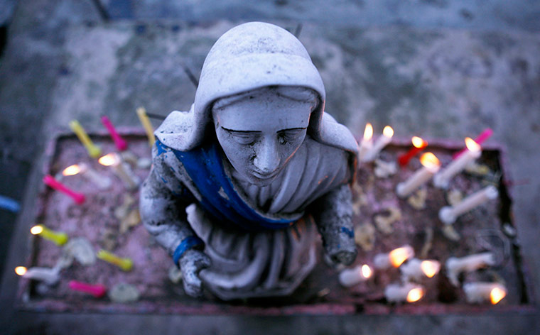 24 hours in pictures: Candles are lit around the statue of Virgin Marry, India