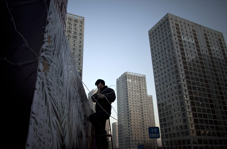 24 hours in pictures:  A worker dismantles Christmas decorations in Beijing, China