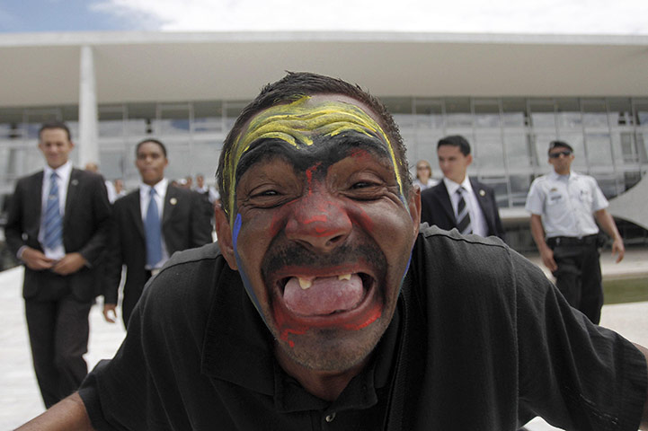24 hours : Brasilia, Brazil: A resident looks at the camera during a demonstration