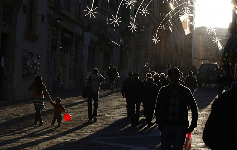 24 hours : Valletta, Malta: A child carries a balloon in the shopping district