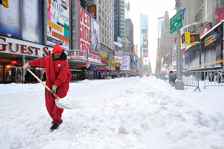 East coast blizzards: A worker shovels snow from Times Square in New York