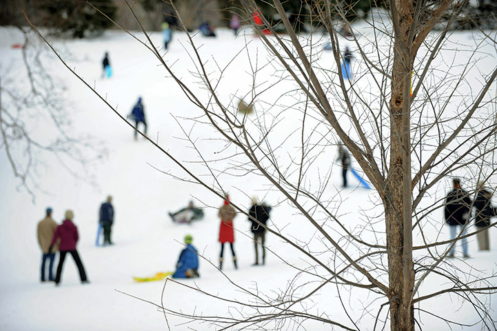 24 hours: New York, USA: Children ride sleds down a hill in Central Park
