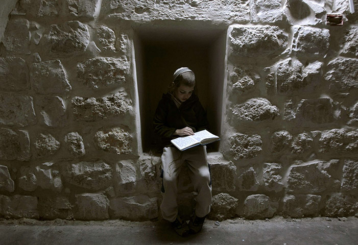 24 hours: Nablus, West Bank: A Jewish boy prays in Joseph's Tomb