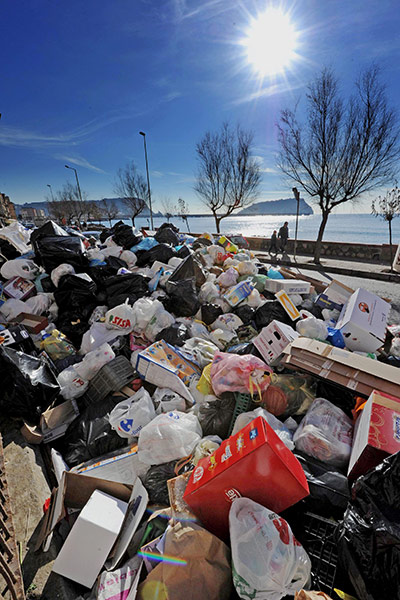 24 hours: Pozzuoli, Italy:  Rubbish piled up along the shore road near Naples