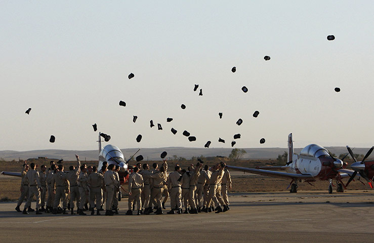 24 hours: Israel: Israeli air force cadets toss their caps during graduation ceremony