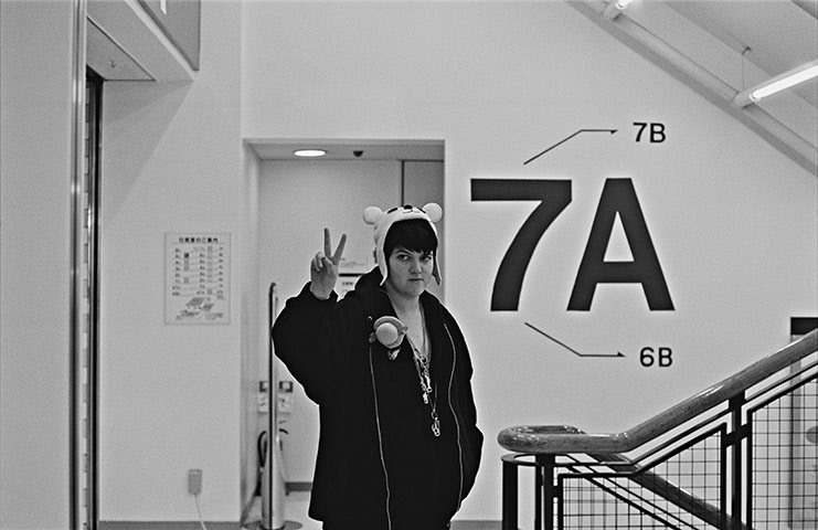 The xx: Romy gives a peace sign to fans while shopping in Japan