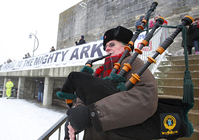 Ark Royal Farewell: Piper Larry Cunningham plays as the HMS Ark Royal sails into Portsmouth