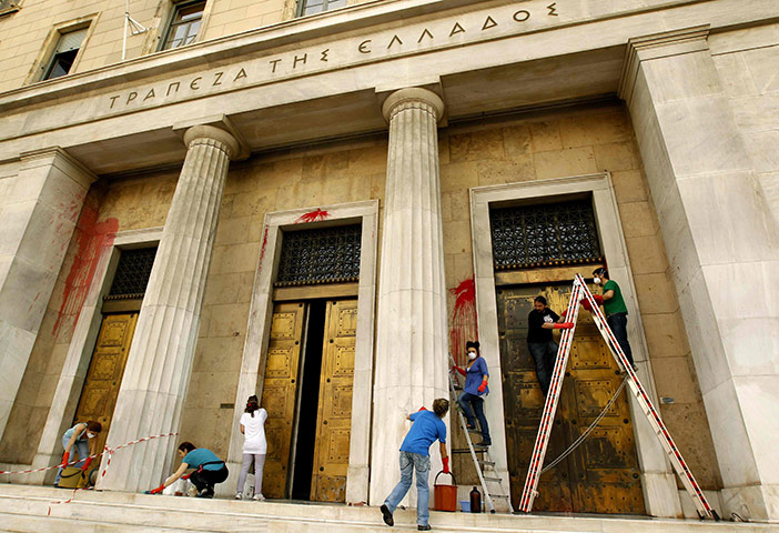 Year in business: Workers clean the main entrance of the Bank of Greece in Athens