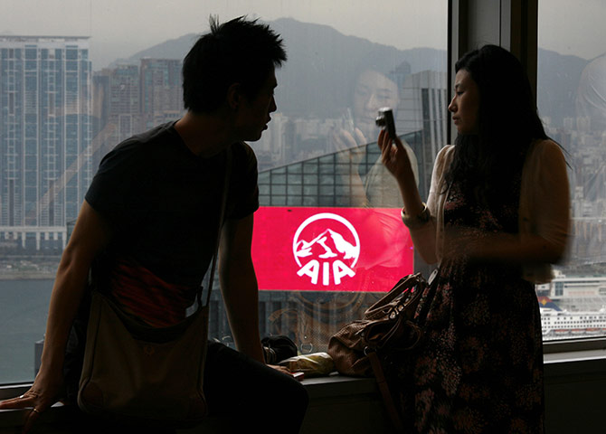 Year in business: A couple in the Bank of China Tower near AIA Central building in Hong Kong