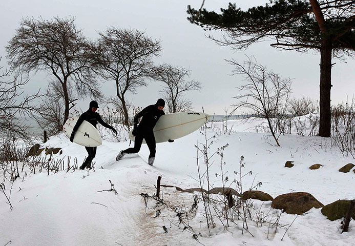 24 hours in pictures: Surfer walk along the icy shore on the Baltic Sea of Timmendorf