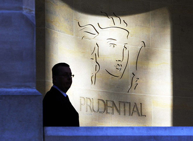 Year in business: A security guard is silhouetted in front a Prudential office in London