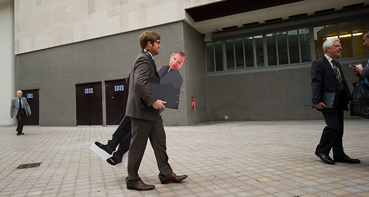 Year in business: A man (L) carries a cardboard figure of M&S CEO Mark Bolland at the AGM