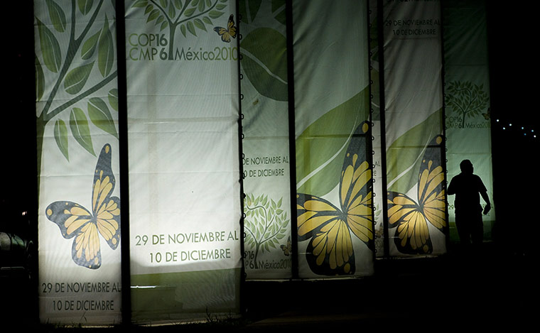 Week in Cancun COP16: A man walks in front of the main entrance of the Cancun