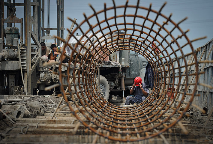 Year in business: Chinese workers rest at a highway under construction in Tianjin, China 