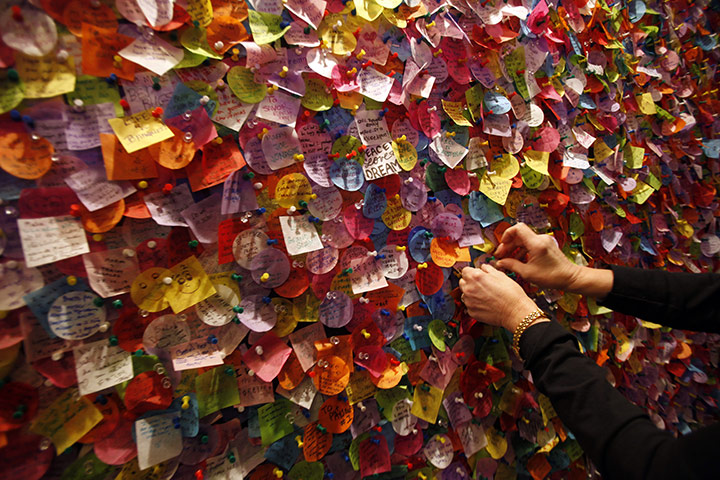 24 hours in pictures: New York, USA: A person pins wishes written on confetti