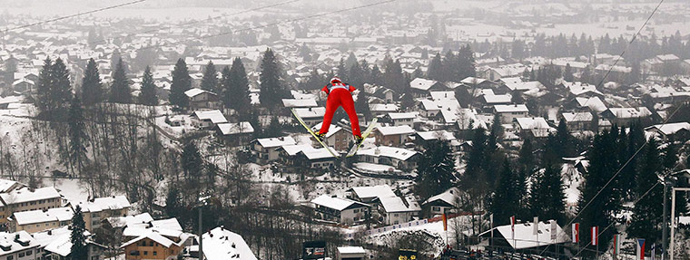 24 hours in pictures: Oberstdorf, Germany: Michael Uhrmann of Germany soars through the air