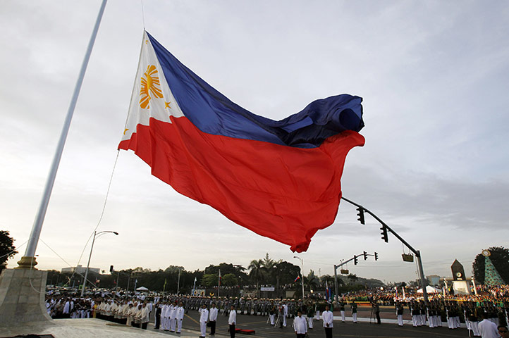 24 hours in pictures: Manila, Philippines: The national flag is raised during celebrations