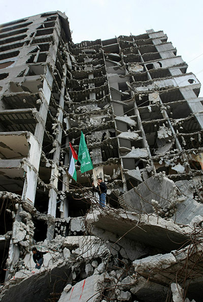 24 hours in pictures: Gaza City: A young Hamas supporter holds Islamic Resistance Movement flag