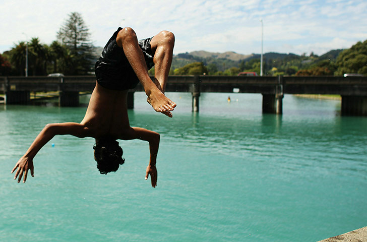 24 hours in pictures: Gisborne, New Zealand: Children dive into the water to cool off