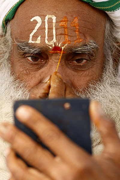 24 hours in pictures: Allahabad, India: A Hindu holy man paints his forehead