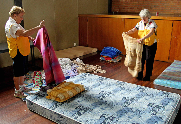 Queensland Flooding: Red Cross volunteers prepare beds for evacuated residents in Bundaberg