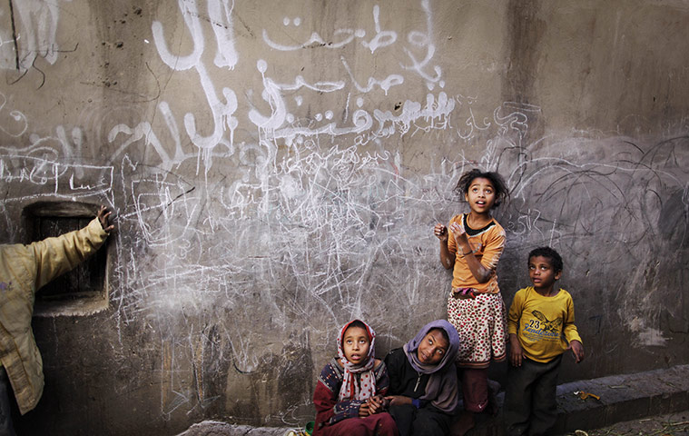 24 Hours: Yemeni children listen to a woman, unseen, talking to them