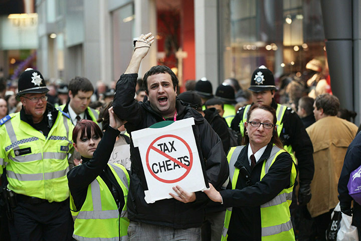Uk Uncut: Protesters are removed by police and security guards Topshop in Birmingham
