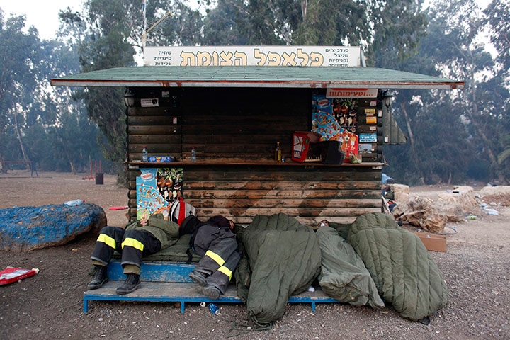Israel forest fire: Firefighters sleep in a tourist parking lot before their next shift