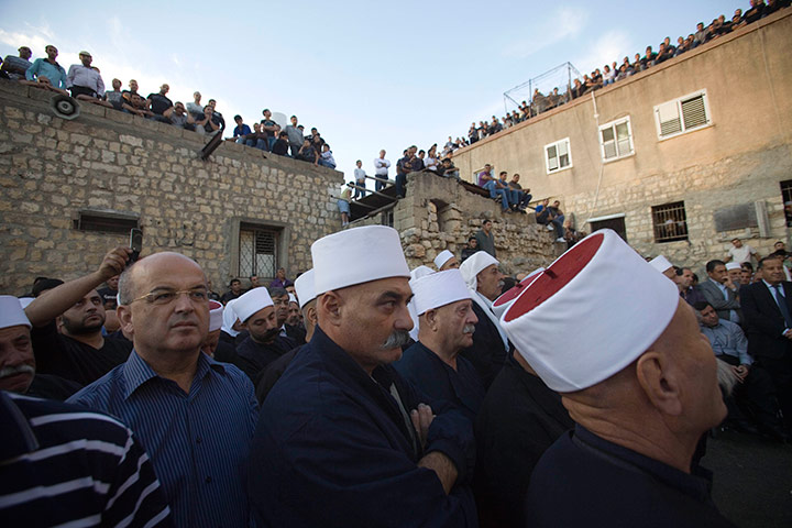 24 hours in pictures: Druze men gather during the funeral of Wissam Abu Rish