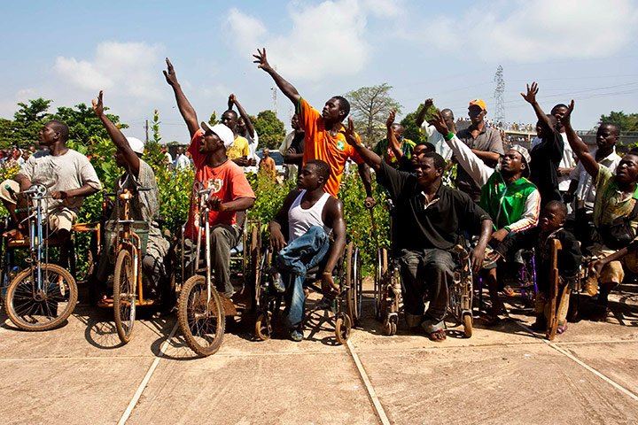 24 hours in pictures: Supporters of Guinea's president elect Alpha Conde cheer