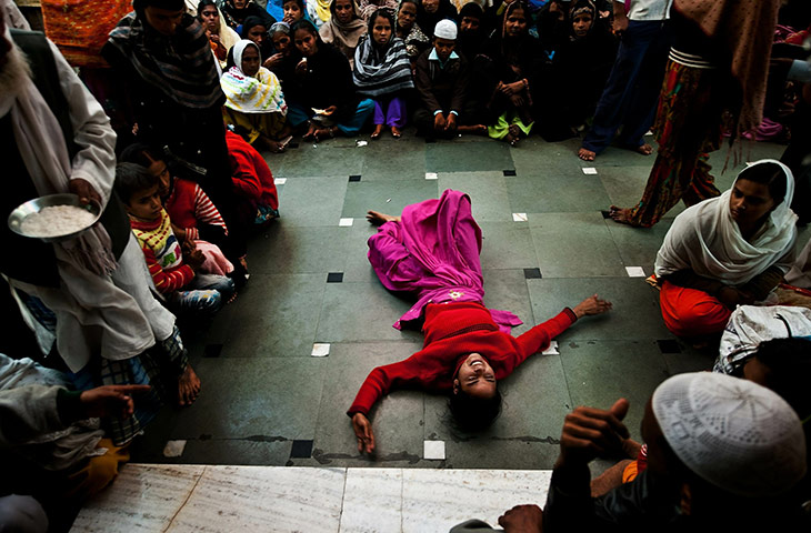 24 hours in pictures: An Indian devotee believed to be possessed by evil spirits