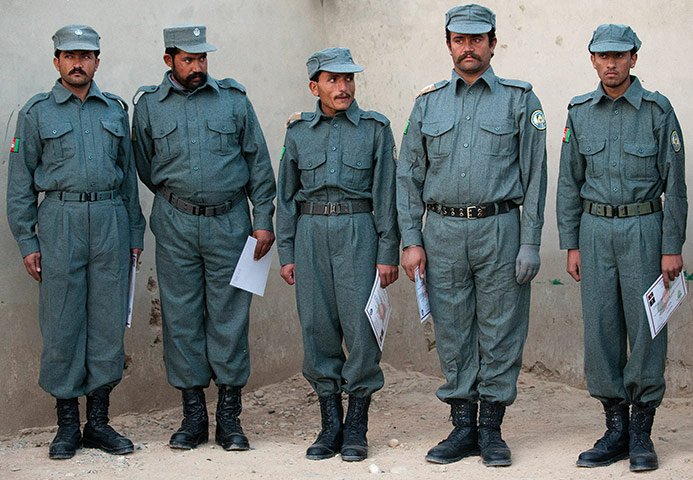 Cameron in Afghanistan : Afghan Graduate Patrol men stand in a line after meeting David Cameron 
