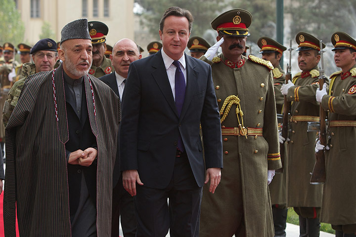 Cameron in Afghanistan : Cameron and Afghan President Hamid Karzai pass an national honor guard