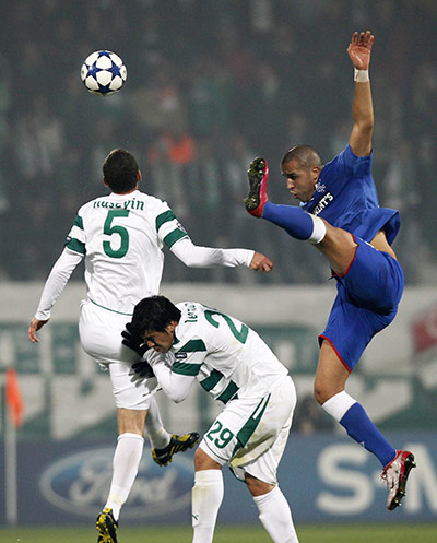Tuesday Champions League: Rangers' Bougherra fights for the ball with Bursaspor's Cimsir and Nunez 