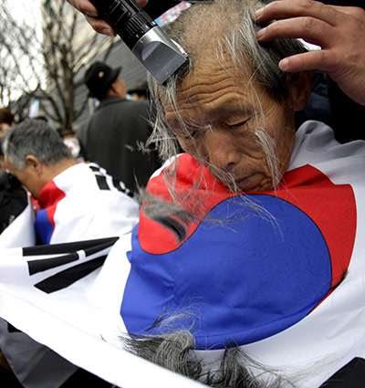 24 hours: Seoul, South Korea: A conservative activist gets his head shaved 