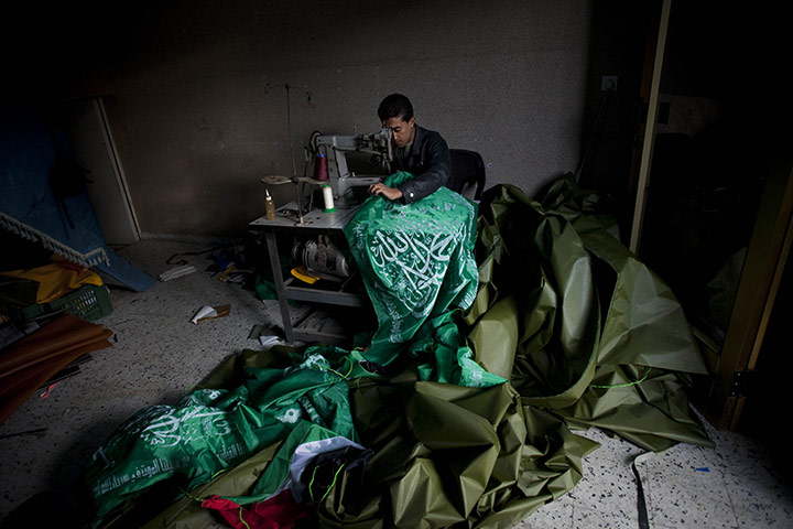24 hours: Gaza Strip: A Palestinian man sews Hamas flags in the Maghazi refugee camp