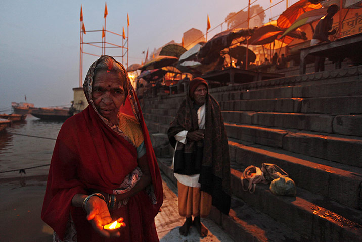 24 hours: Varanasi, India: A Hindu devotee offers prayers at the Dashashvamedh ghat