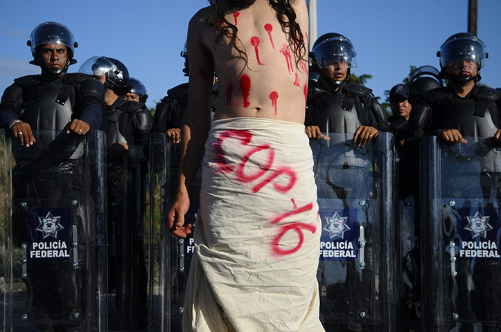 COP16 updates: An activist at a protest march in Cancún