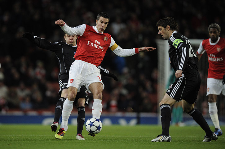 Arsenal v Partizan: Robin Van Persie is tackled by a Partizan Belgrade player