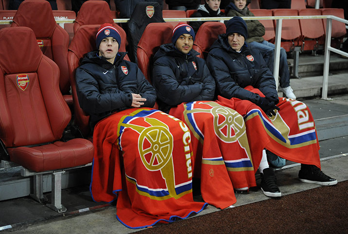 Arsenal v Partizan: Wilshere, Walcott and Bendtner are snuggly and warm on the bench