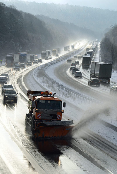 Cold weather abroad: Homberg, Germany: A snow plough clears a stretch of the A7 motorway 